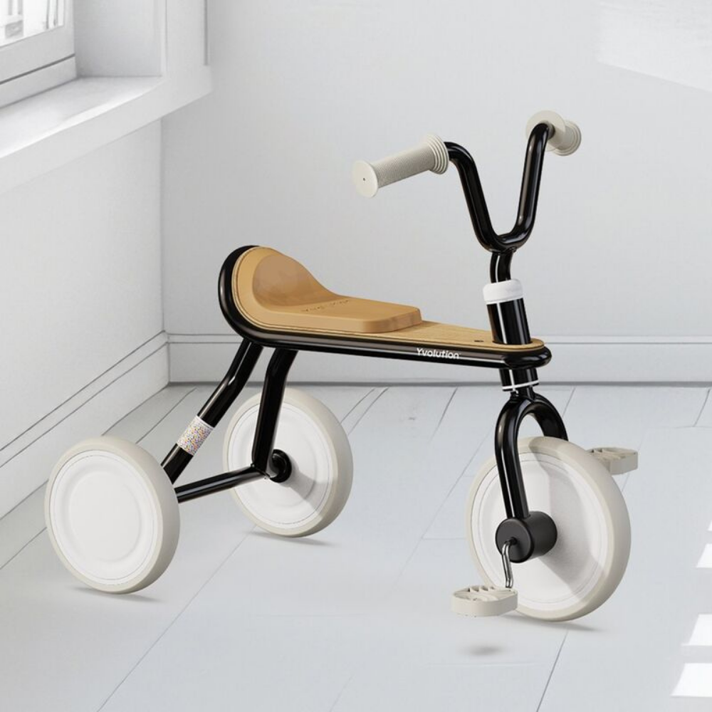 Modern children's tricycle with wooden seat on a white floor