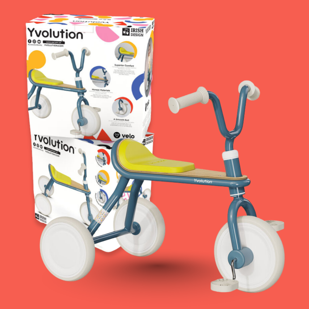 Children's tricycle with Yvolution packaging on a red background