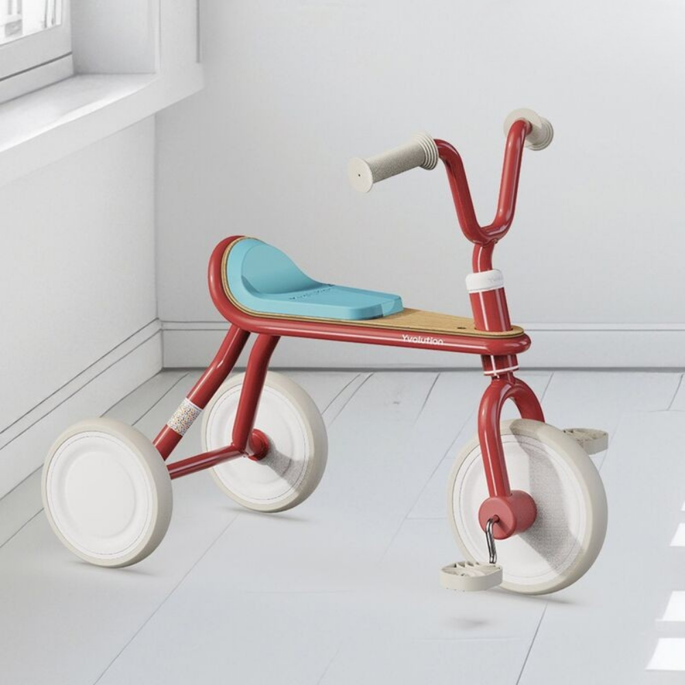 Red tricycle with a blue seat on a white floor