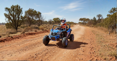 A child in a helmet drives a blue off-road buggy down a dusty Australian trail, capturing a sense of wild adventure.