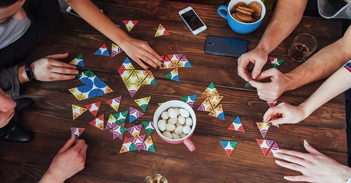 People playing a game on a wooden table