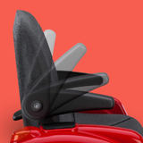 Close-up of a black car seat with red base on a red background