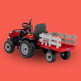 Red toy tractor with a gray trailer on an orange background