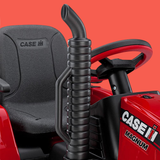 Close-up of a red Case IH Magnum tractor seat and steering wheel with a black handle on a red background.