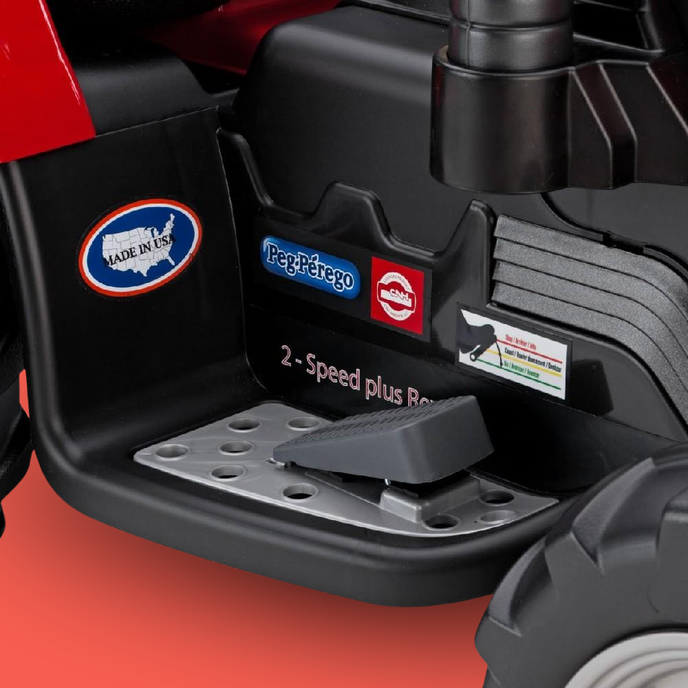 Close-up of a toy tractor's pedal with brand logos on a red background