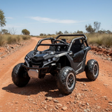 Black off-road vehicle on a dirt road with a clear sky