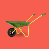 A John Deere wheelbarrow with a green metal tray, yellow frame and handles, and a black tire, shown against a solid coral red background.