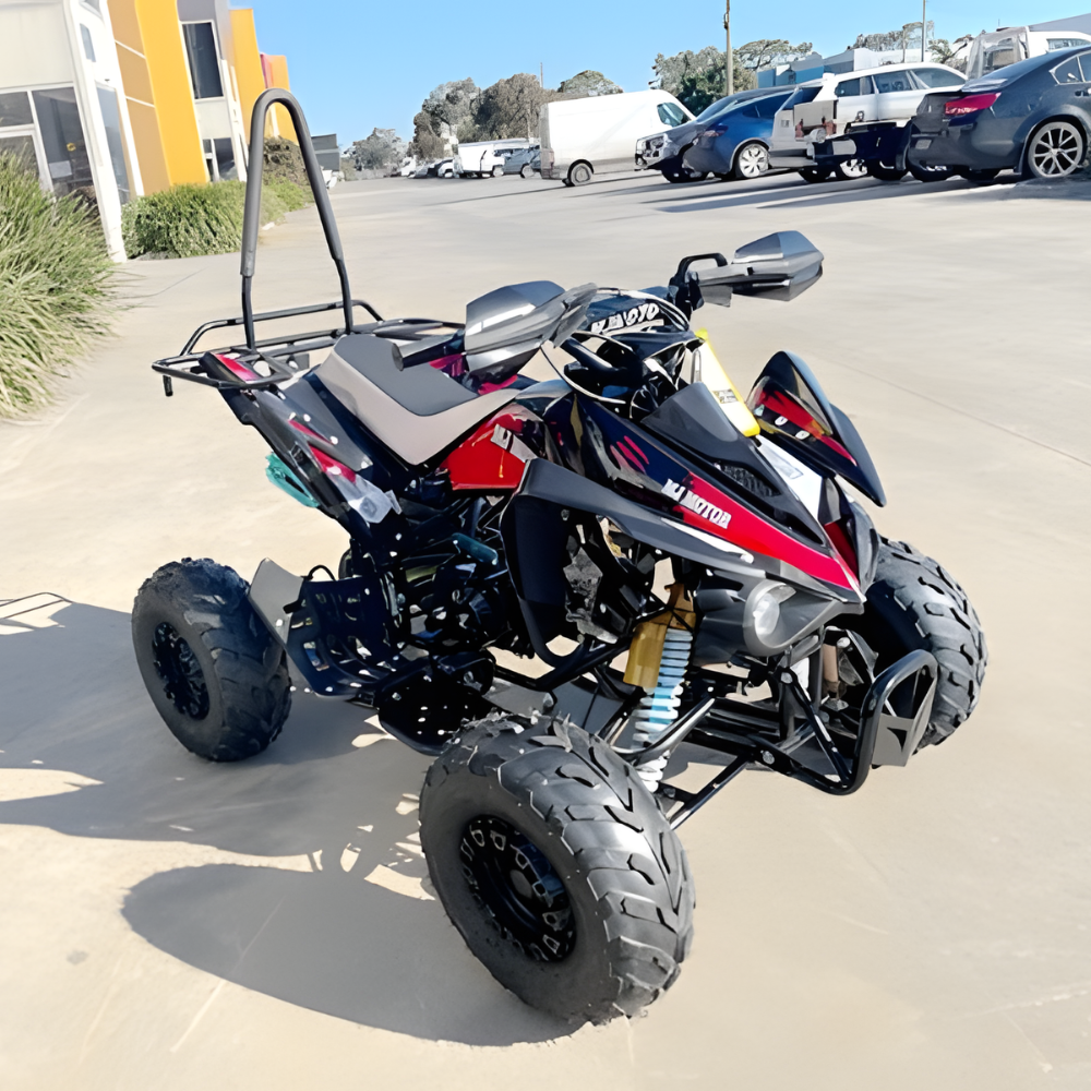 ATV parked on a concrete surface with a parking lot in the background