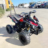 ATV parked on a concrete surface with a parking lot in the background