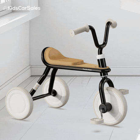 A black and tan Yvolution Velo Trike with white wheels rotates 360 degrees against a clean, white indoor background.