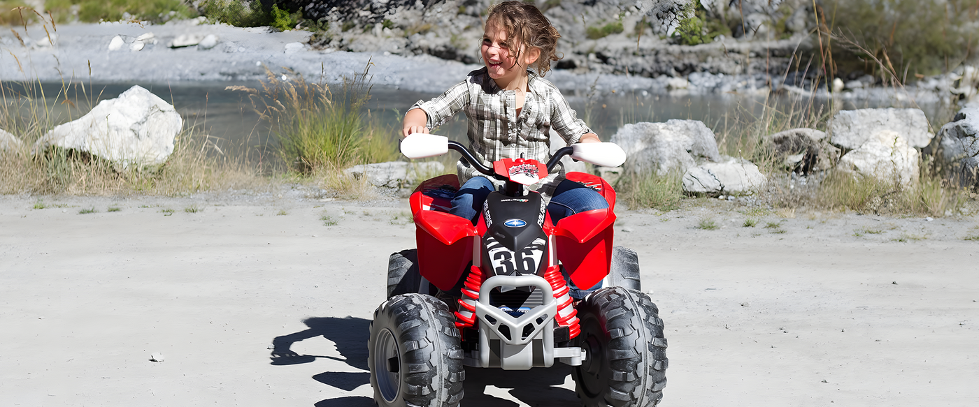 a-child-riding-a-red-and-black-quad-bike-with-large-off-road-tyres-enjoying-an-outdoor-adventure