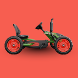 Toy go-kart with red wheels on a red background