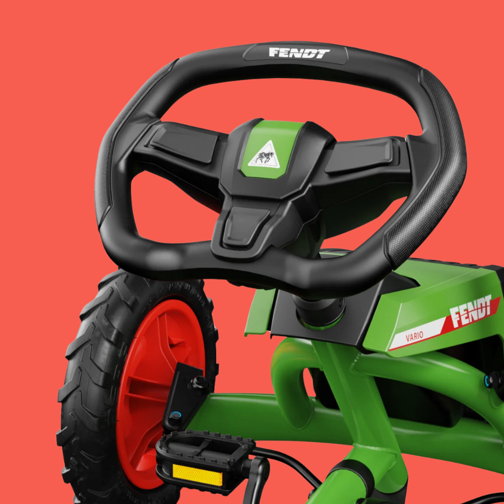 Green and black toy vehicle with a steering wheel on a red background