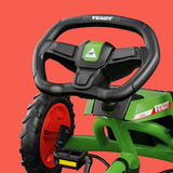 Green and black toy vehicle with a steering wheel on a red background