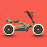 Children's pedal-go-kart with basket on a red background