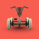 Children's pedal-go-kart on a red background