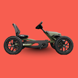 Green and black pedal go-kart on a red background