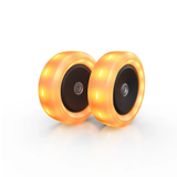 Two orange scooter wheels on a white background