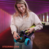 Woman holding a scooter with a steering lock feature, set against a blurred indoor background.