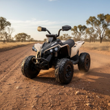 ATV driving on a dirt road with trees in the background