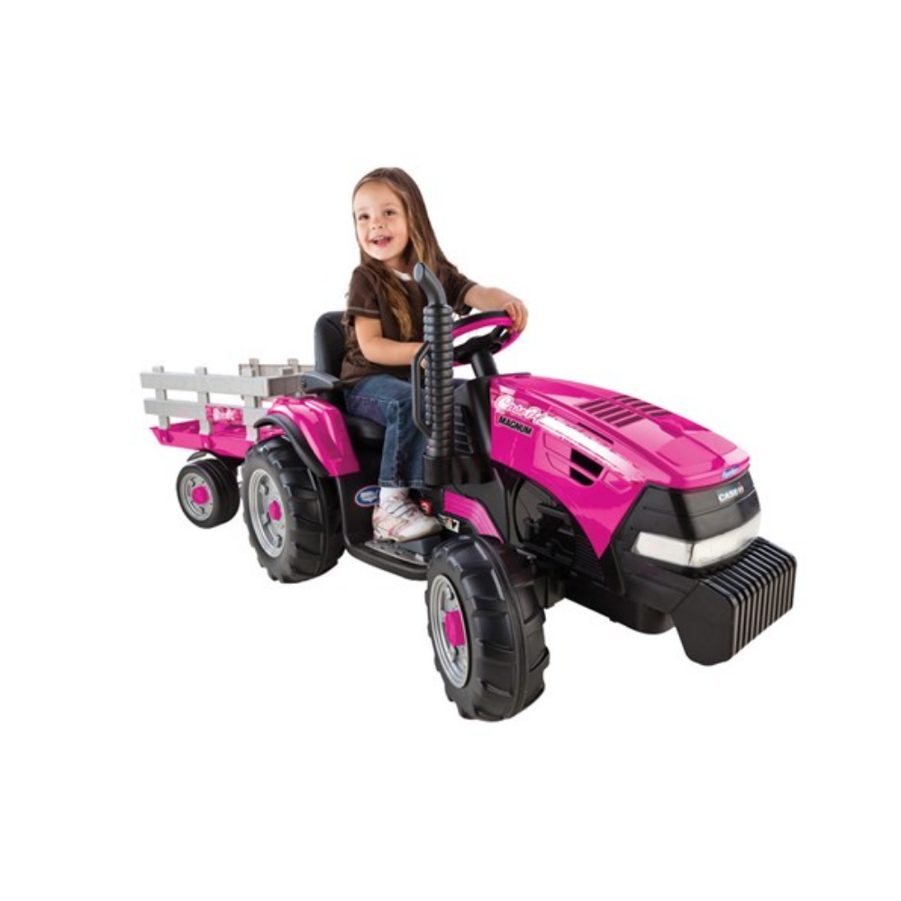 Child sitting on a pink toy tractor with a white background