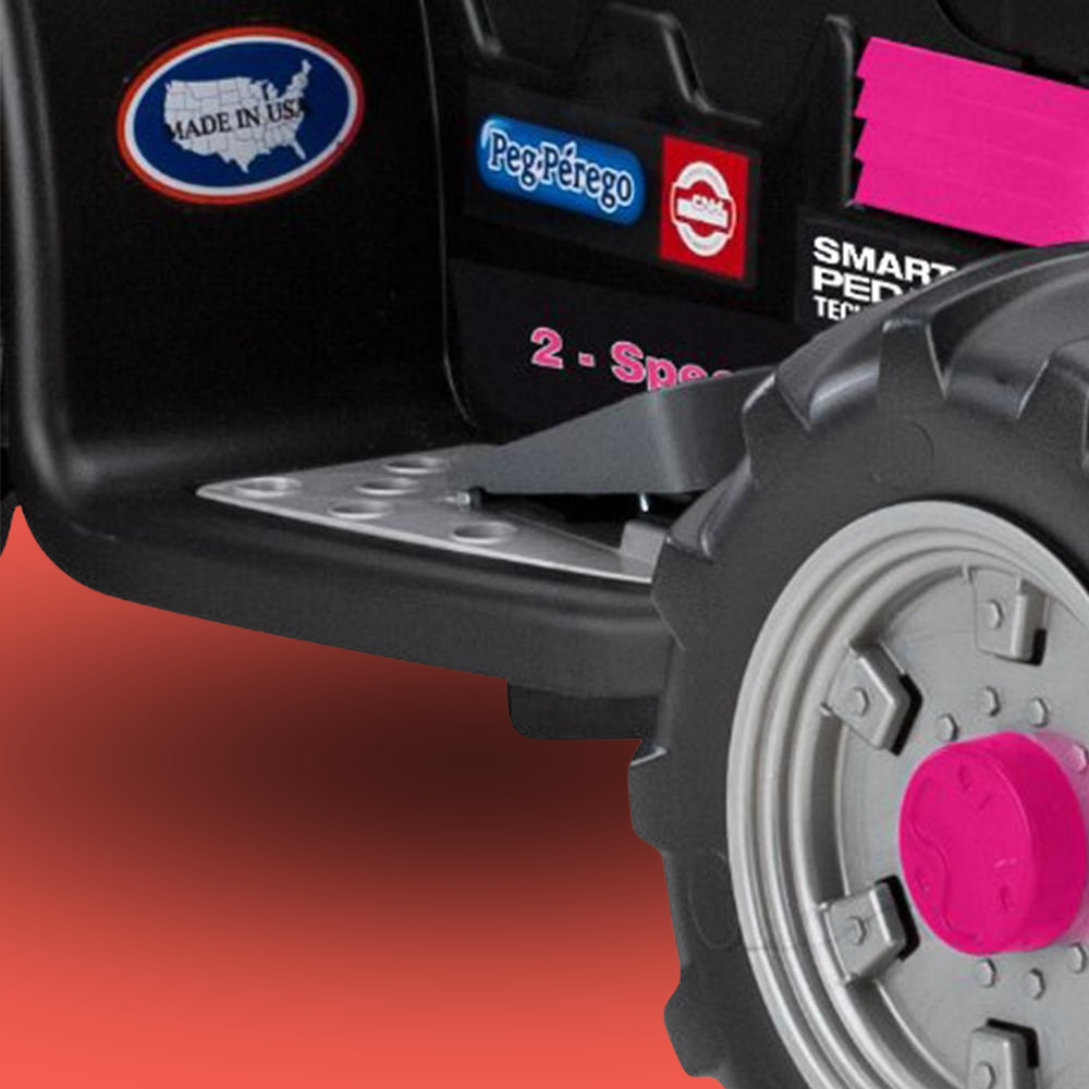 Close-up of a toy vehicle with branding logos on a red background