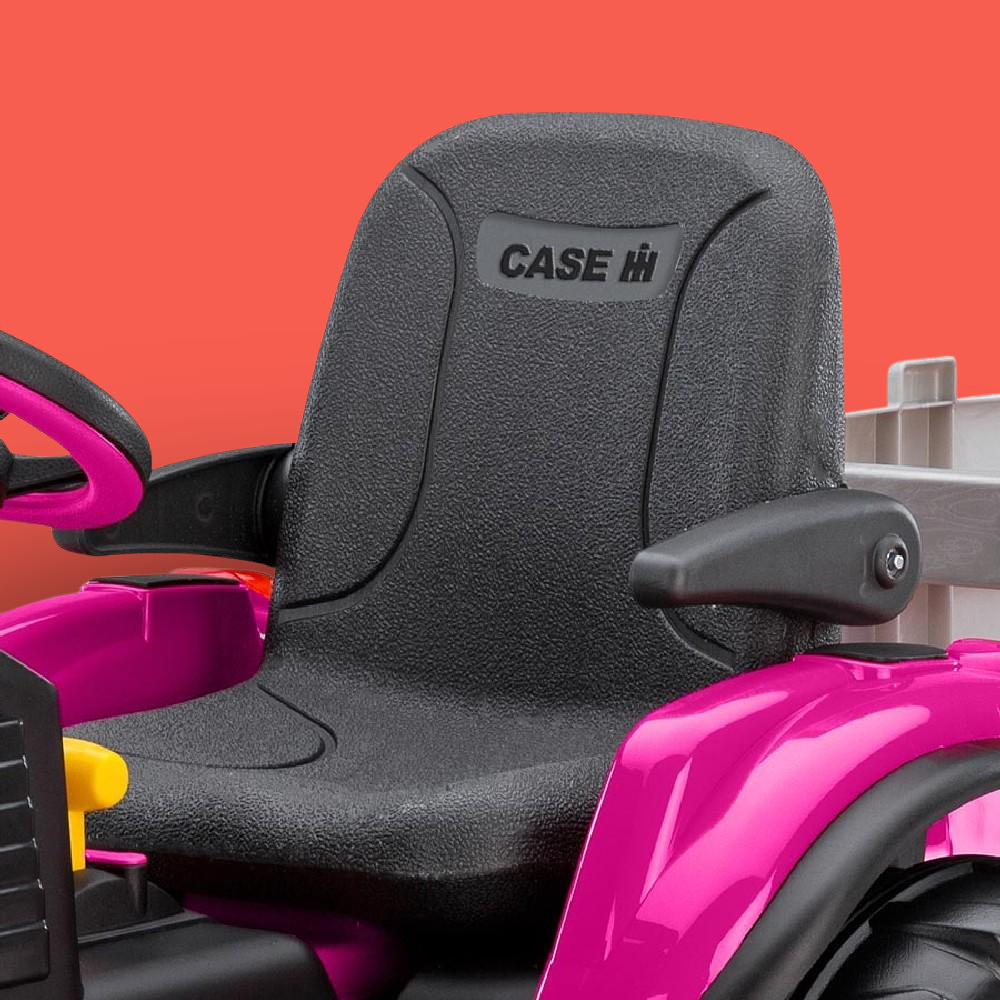 Close-up of a black seat with 'Case' logo on a pink and black vehicle against an orange background