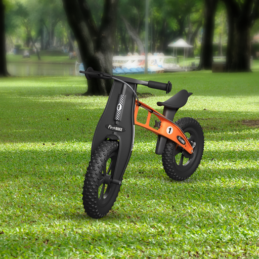 outdoor park with FirstBIKE Lightweight Fat Cross Balance Bike With Brake - Orange