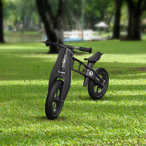 outdoor park with the FirstBIKE Limited Edition Balance Bike with Brake - Black