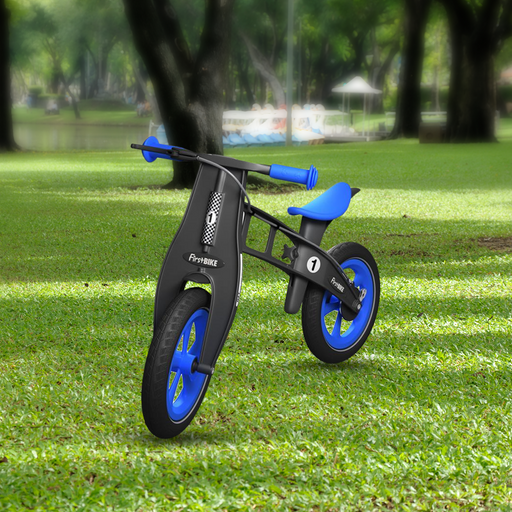 outdoor park with the FirstBIKE Limited Edition Balance Bike with Brake - Blue
