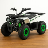 Studio shot of the GMX 125cc quad bike on a wooden floor background with a clean white wall, showcasing the vehicle’s side profile and aggressive tyre tread.