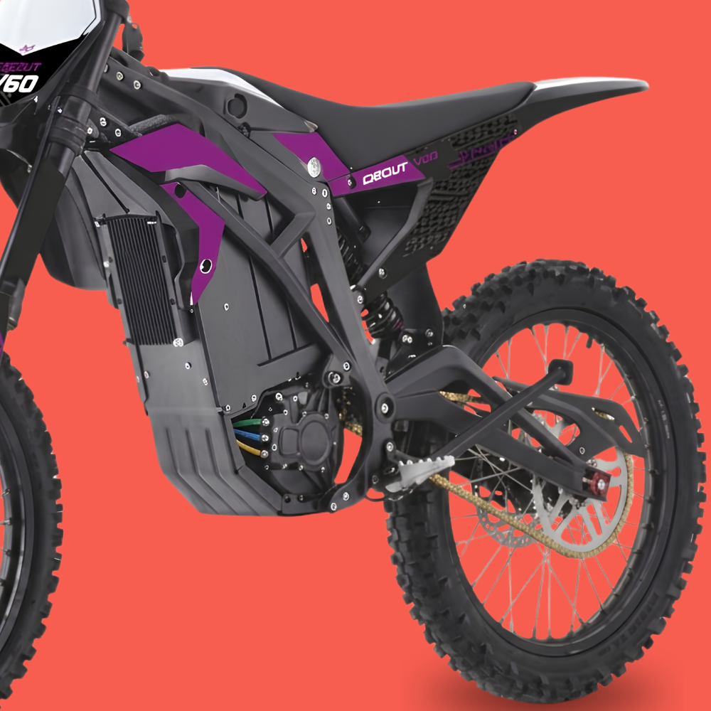 A close-up side view of an electric dirt bike or moped showing the black frame, battery housing, rear wheel, and purple and white graphics on the bodywork, set against a solid orange-red background.