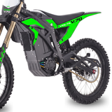 A close-up side view of an electric dirt bike, showing the black and bright green body panels, black seat, gold front fork, and black knobby tires against a white background.