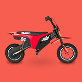 A red and black mini dirt bike with flame decals and the number 84, shown from a side profile on a solid red background.