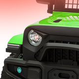 Close-up of a green and black off-road vehicle's front grille and headlight.