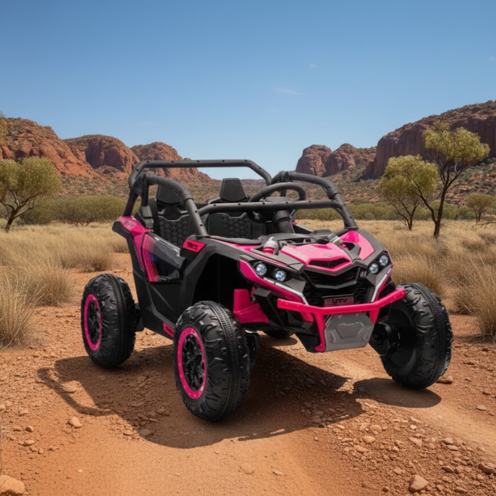 Pink and black off-road vehicle on a dirt road with desert landscape in the background