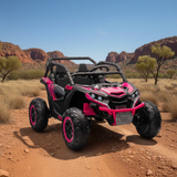 Pink and black off-road vehicle on a dirt road with desert landscape in the background