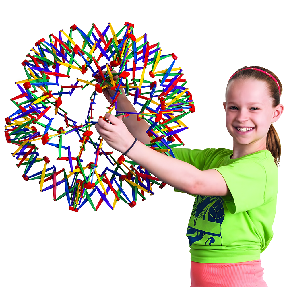 Smiling girl wearing a green shirt, holding a multi-coloured Hoberman Sphere that is partially expanded