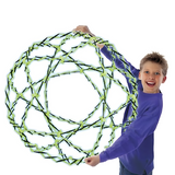 Smiling boy holding a large, expanded Hoberman Sphere, appearing to float in the air on a white background