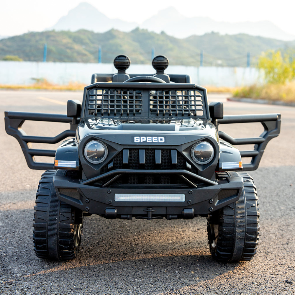 Front view of the black Jeep-inspired remote-controlled ride-on electric car with the doors open, on an outdoor road.