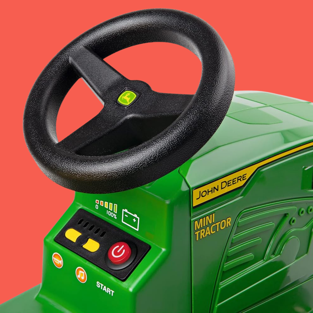 Green toy tractor with steering wheel on a red background