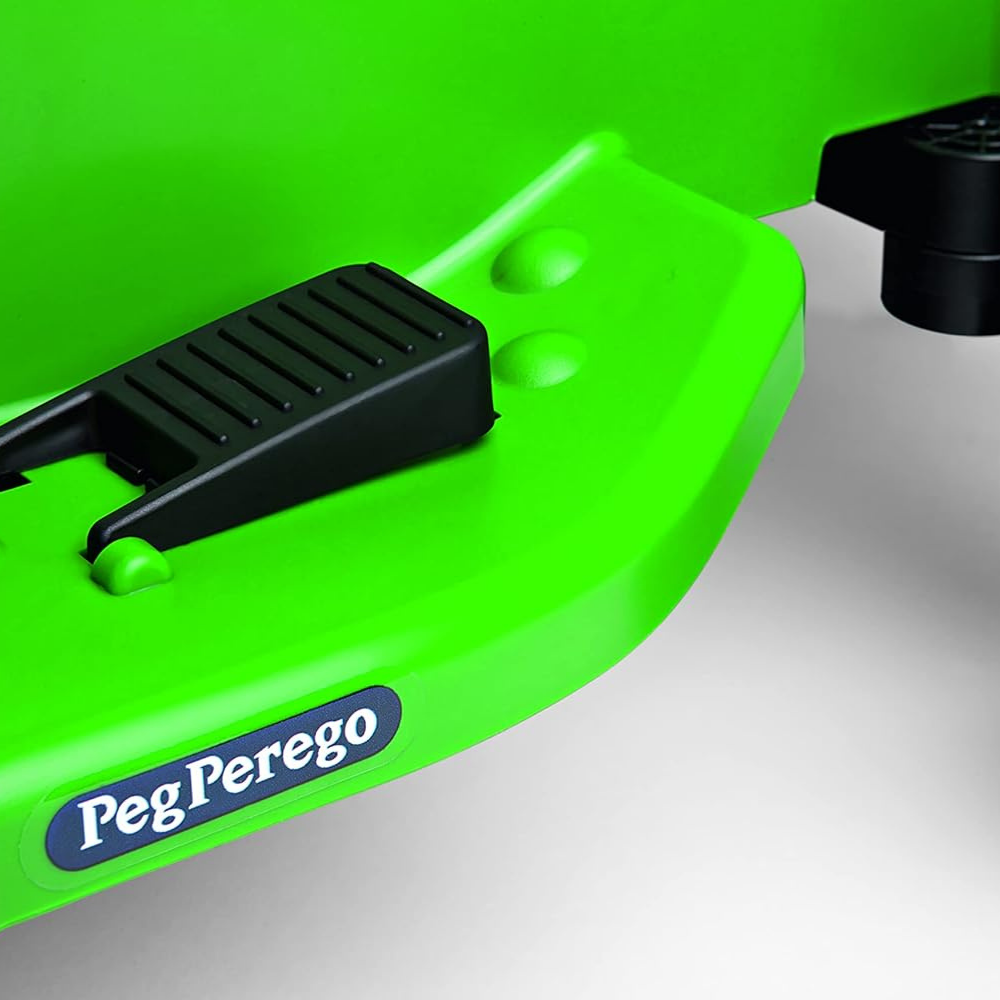 Green toy train track with black control device on a green background, featuring Peg Perego branding.
