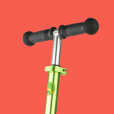 Green scooter handlebar with black grips on a red background