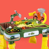 A John Deere Kids plastic play center toy with green and yellow construction-themed surfaces, toy tractors, a small excavator, animal figures, and a red background.