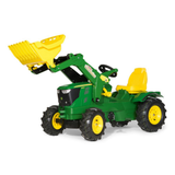 Toy tractor with yellow bucket on a white background