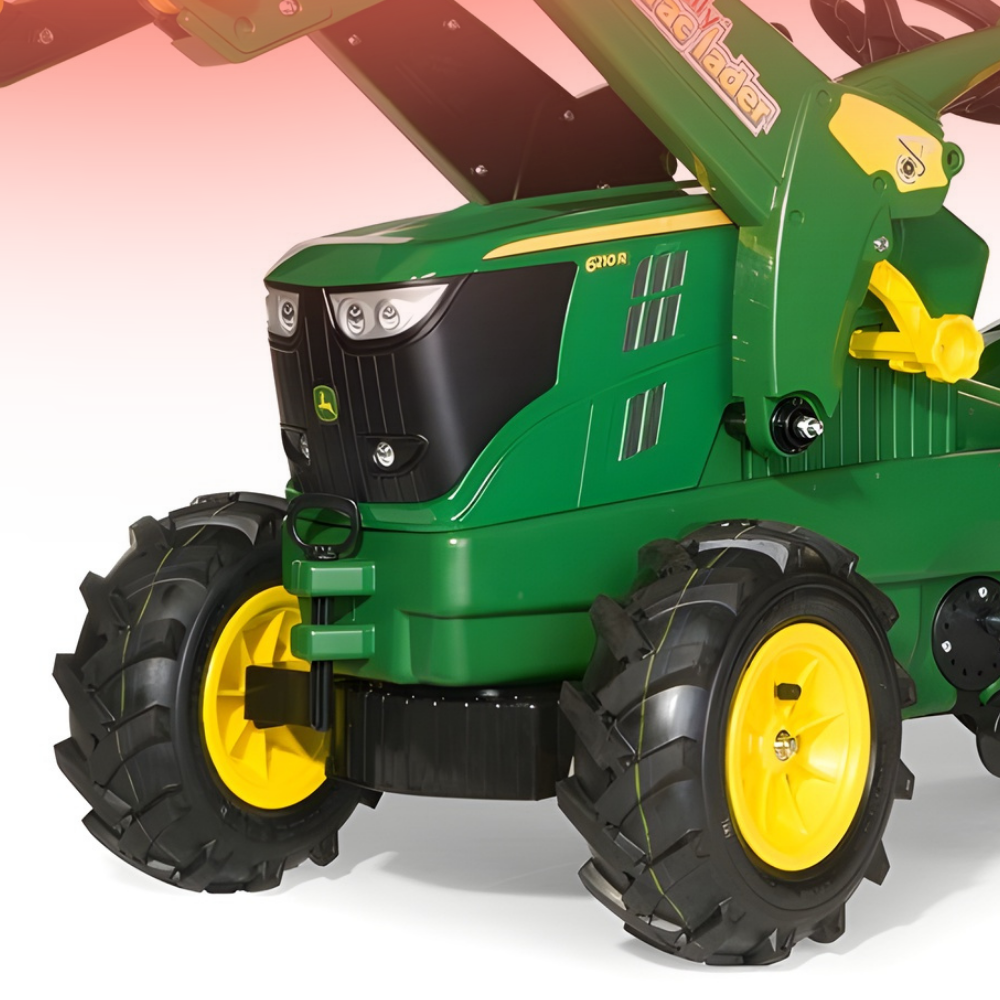 Green toy tractor with black tires and yellow wheels on a white background