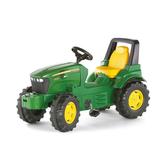 Toy tractor with green body and yellow accents on a white background