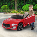 kid riding a red bentley ride on car