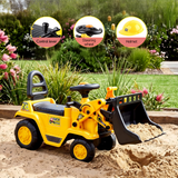 Yellow and black ride-on toy bulldozer with a front bucket, shown in a sandy play area with a garden background. Three circular callout graphics at the top label included parts: a control lever, steering wheel, and helmet.