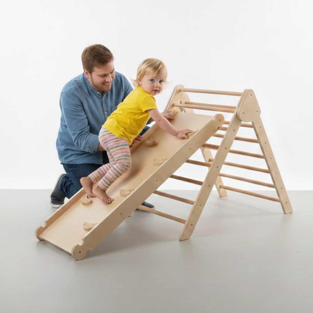 Man and child playing on a wooden climbing toy against a white background